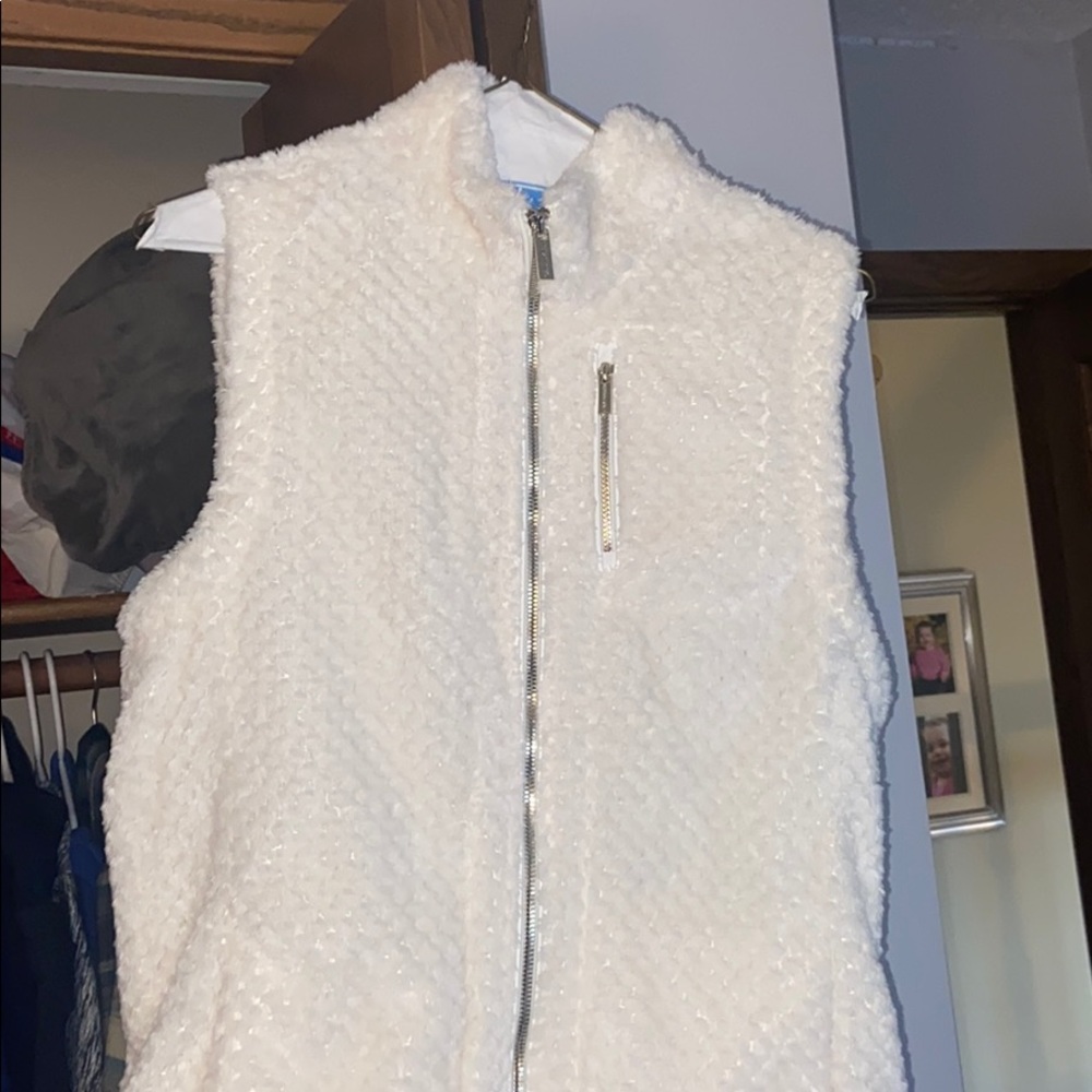 Fuzzy white Calvin Klein vest with gold zipper